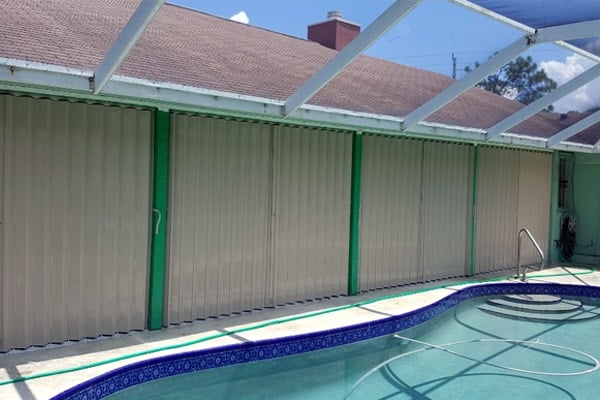 Full patio enclosure protected with Supernova Accordion Shutters in Florida